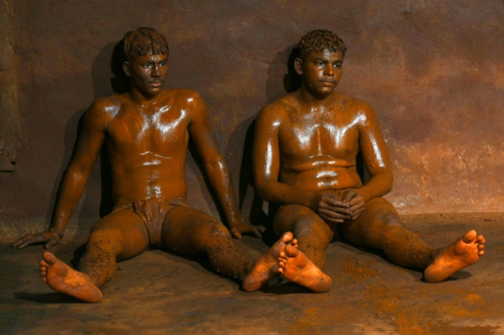 Young wrestlers rest as they watch others train at the Shree Shahu Vijayi Gangavesh Talim, a residential gymnasium in Kolhapur, India