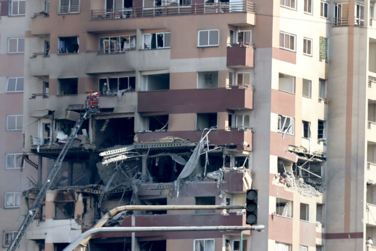 https://d.ibtimes.com/en/full/4604536/rescue-teams-work-outside-building-targeted-israeli-strike-iranian-capital-tehran.jpg