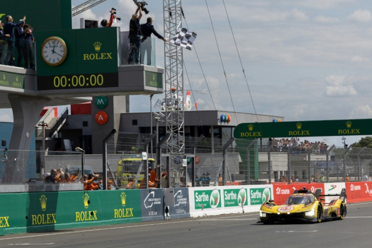 Robert Kubica takes his Ferrari across the line to win the 2025 Le Mans 24 Hours