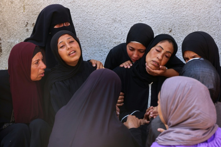 Palestinians mourn loved ones killed as they waited to queue for food in Gaza on Tuesday.
