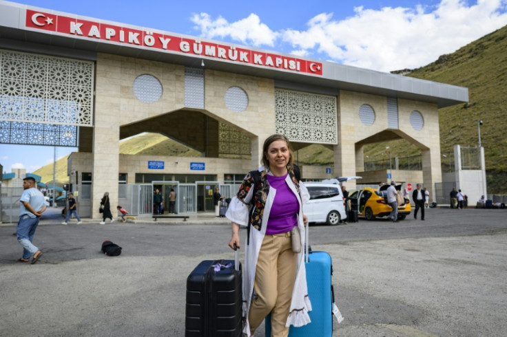 Homa, a 40-year-old Iranian, arrives in Turkey through the Razi-Kapikoy border crossing, north-eastern Turkey on June 18, 2025