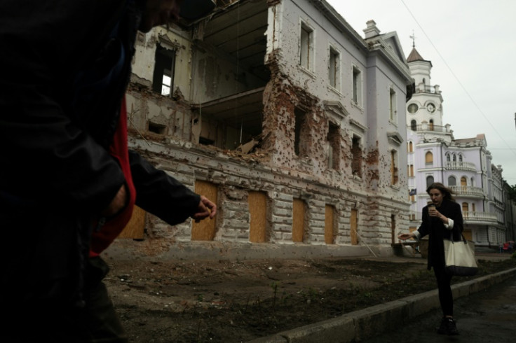 Pedestrians walk past a monument destroyed by Russian bombing in Sumy, north-eastern Ukraine, on June 12, 2025, amid the Russian invasion of Ukraine. Sumy was the starting point for a Ukrainian raid on the Russian region of Kursk, partly occupied by Kiev