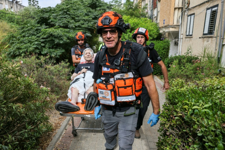 Israeli first responders evacuate an injured woman following an Iranian strike on a residential building in the Ramat Aviv area in Tel Aviv on June 22, 2025. At least 16 people were hurt and at least one impact was reported in central Israel after Iran la