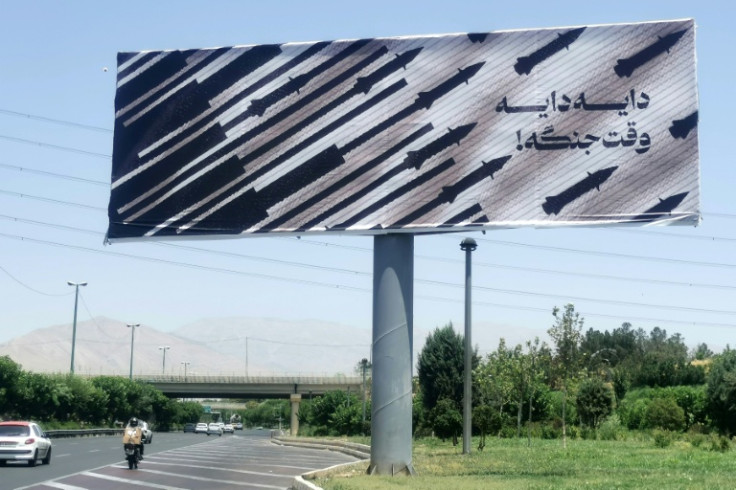 Commuters drive past an anti-Israel billboard in Tehran