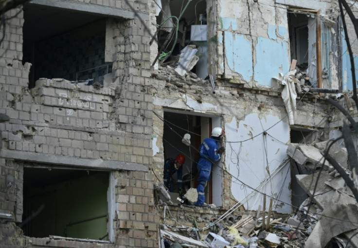 Ukrainian rescuers conduct a search operation in a residential building, heavily damaged following a strike in Kyiv on June 23, 2025, amid the Russian invasion of Ukraine