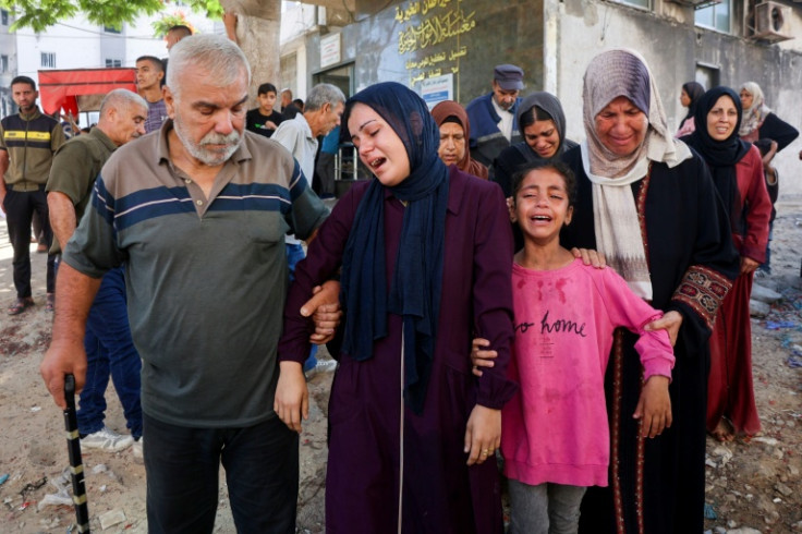 Mourners cry during a funeral of a person killed while attempting to get aid at a distribution point