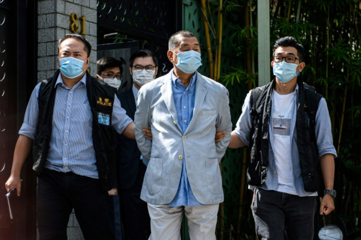High-profile legal battles have not ended: the case of media tycoon Jimmy Lai (C) continues