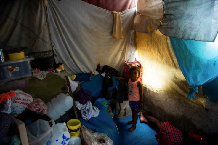A child stands in a temporary shelter near the National Palace in Port-au-Prince, Haiti, on June 6, 2025