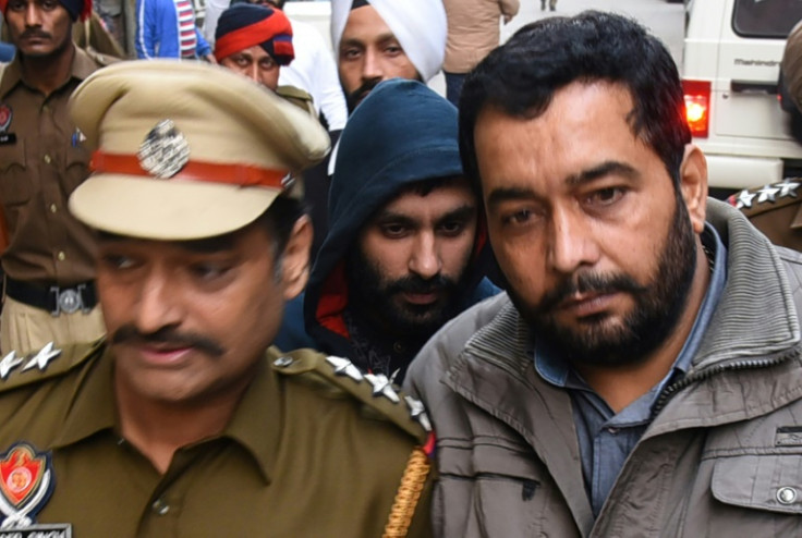 British Sikh man Jagtar Singh Johal (C) has been detained in India since 2017