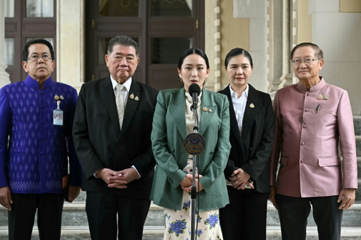 Prime Minister Paetongtarn Shinawatra (C) speaks next to Deputy Prime Minister Phumtham Wechayachai (2nd L) during a news conference after her suspension