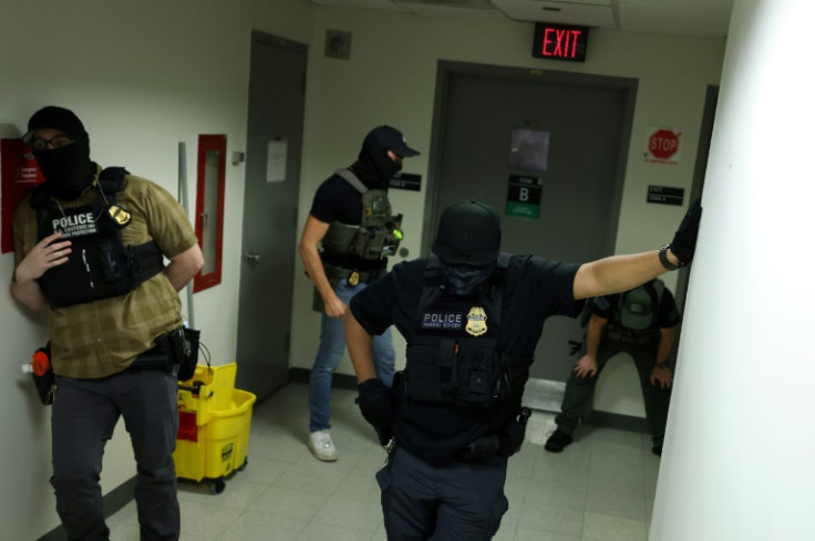 Armed agents with shields from different federal agencies outside hearings in a Manhattan federal tower block