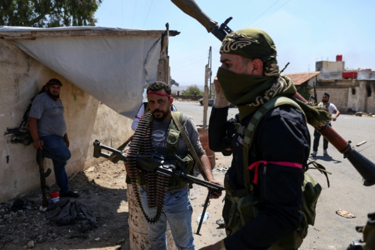 Armed Bedouin gather in the village of Al-Mazraa outside Sweida as clashes flare with Druze fighters, a day after the Syrian army withdrew from the province, heartland of the Druze minority.
