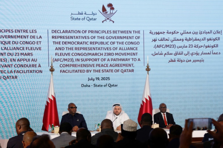Qatar's junior foreign minister Mohamed Bin Mubarak Al-Khulaifi sits in the centre as the Democratic Republic of Congo and Rwanda-backed armed group M23 sign a ceasefire deal