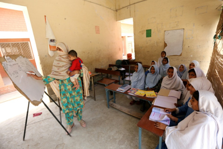 Teacher Nazia Hussain (L) and her class at a government school in southwestern Punjab province