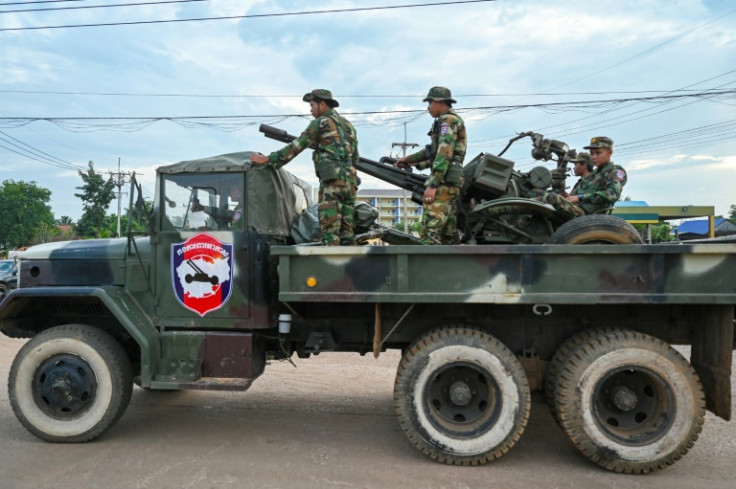 Cambodian soldiers stand on a military truck with an anti-aircraft gun in Oddar Meanchey province on July 25, 2025