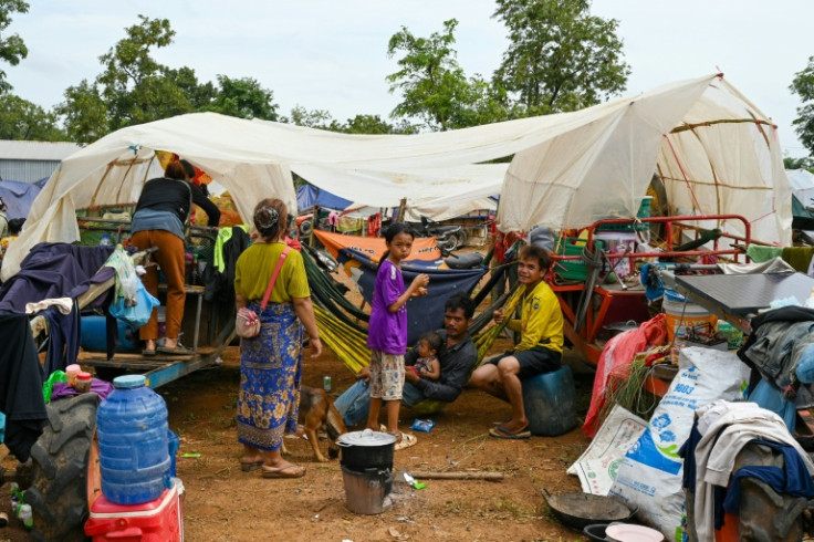 Hundreds of Cambodian evacuees huddled in makeshift tents, surrounded by emergency food rations and their hastily packed clothes