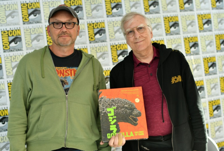 Authors Steve Ryfle (L) and Ed Godziszewski pose with a copy of their book about the first 70 years of the "Godzilla" franchise