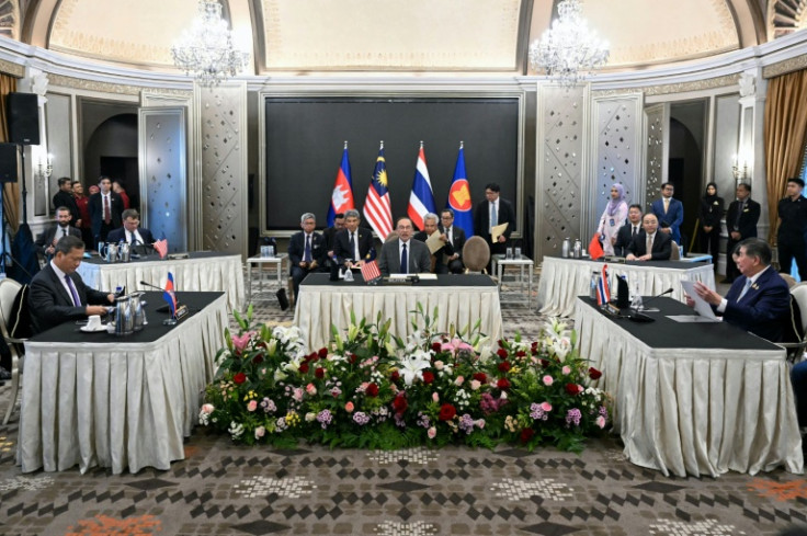 Malaysia's Prime Minister Anwar Ibrahim (centre) looks on as Cambodia's Prime Minister Hun Manet (left) and Thailand's acting Prime Minister Phumtham Wechayachai (right) take part in talks on a possible ceasefire in Putrajaya