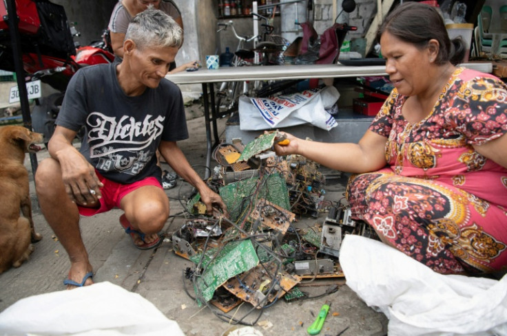 Dexter Barsigan and his wife Rosalie Sedantes strip parts from discarded electronic equipment in Manila. Barsigan has spent the past 13 years making a living with his bare hands and a pair of pliers, stripping scrapped laptops metal he can sell to junk sh