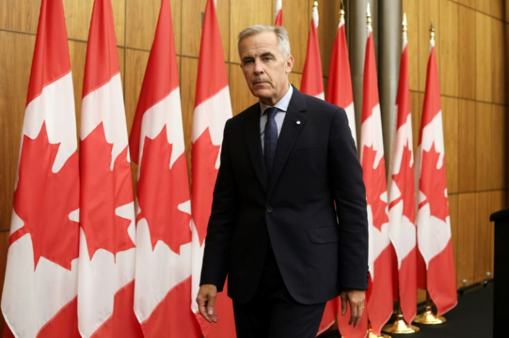 Canadian Prime Minister Mark Carney exits a press conference after announcing plans to recognize a Palestinian state