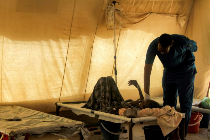 A doctor visiting a cholera patient at an isolation unit outside the Bashayer Hospital, south of Khartoum. Nearly 100,000 cases have been reported since July 2024