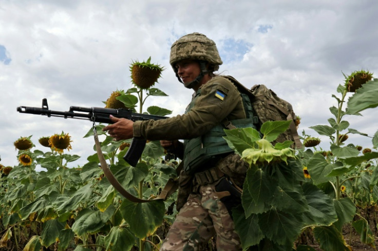 This handout photograph released by the Ukrainian Armed Forces on August 11, 2025 shows Julia, 40, a new recruit, taking part in a training exercise at an undisclosed location in the Zaporizhzhia region