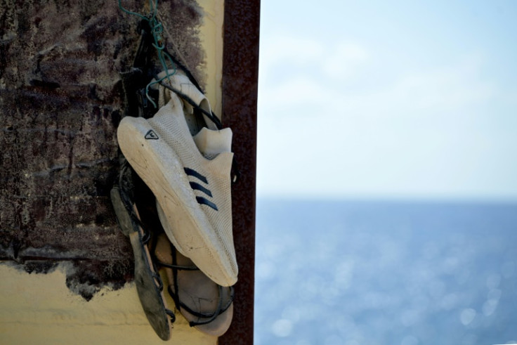 Shoes hanging on the "Porta di Lampedusa" monument, known as "The door of Europe", dedicated to the migrants who have died in the Mediterranean sea trying to reach Europe, on September 25, 2023 on the Italian island of Lampedusa