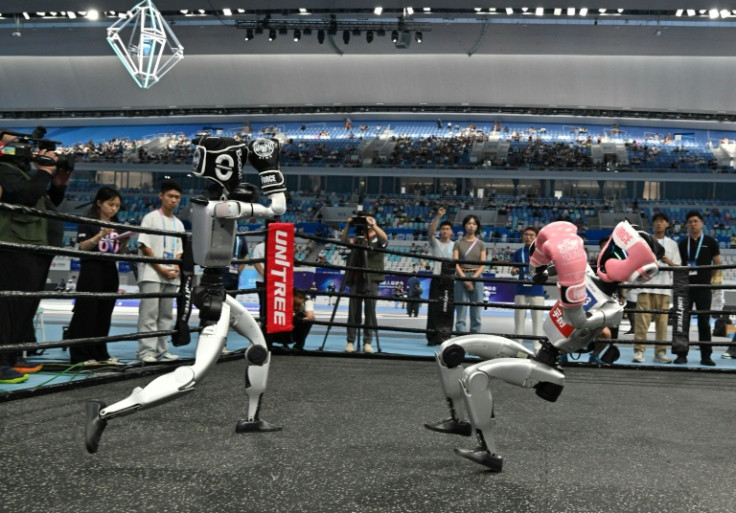 Two robots fight in a free combat style event during the World Humanoid Robot Games in Beijing on Friday