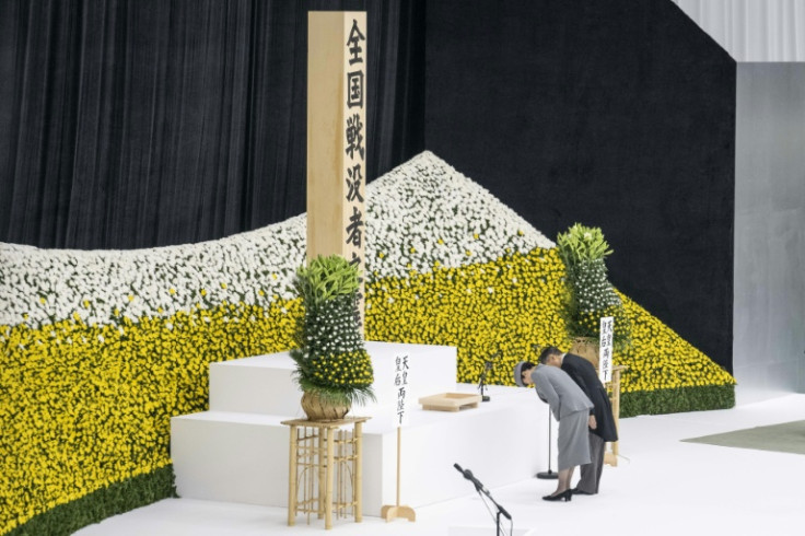 Emperor Naruhito and Empress Masako bow as they attend a memorial service marking the 80th anniversary of Japan's surrender in World War II at the Nippon Budokan hall in Tokyo
