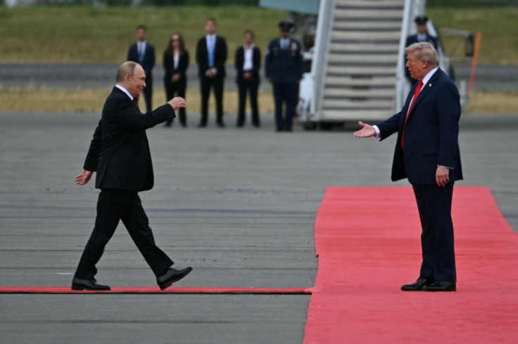 US President Donald Trump greets Russian President Vladimir Putin on the tarmac after they arrive at Joint Base Elmendorf-Richardson