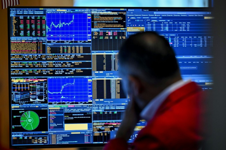 A trader works on the floor of the New York Stock Exchange on August 13