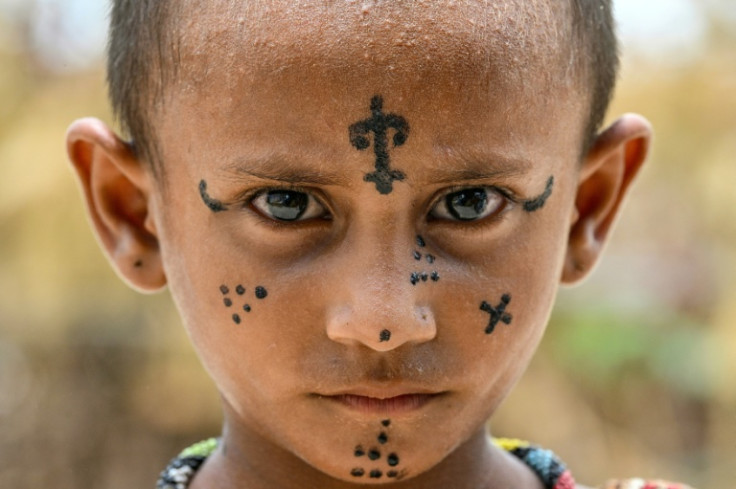 Six-year-old Pooja shows off her tattoos at the Jogi Colony, a Hindu-majority district in Umerkot, Pakistan