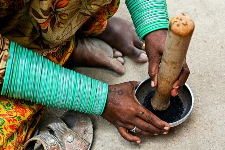 The tattoo ink is made by grinding charcoal powder into goat milk