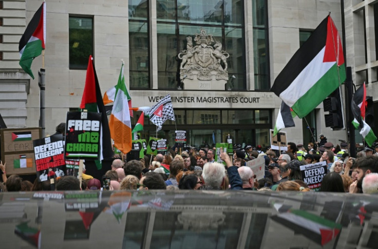 Supporters of the Irish rap band Kneecap fly Palestinian flags outside Westminster Magistrates' Courts in London where singer Mo Chara was appearing on a terror charge for brandishing a Hezbollah flag