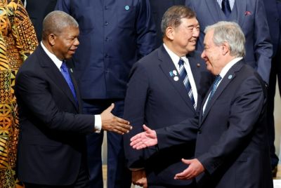 Angolan President Joao Lourenco (L) greets UN Secretary-General Antonio Guterres (R) during the 9th Tokyo International Conference on African Development in Japan