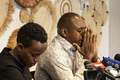 Kenyan journalist and human rights activist Boniface Mwangi (R) at a press conference on June 2, following his detention in Tanzanian