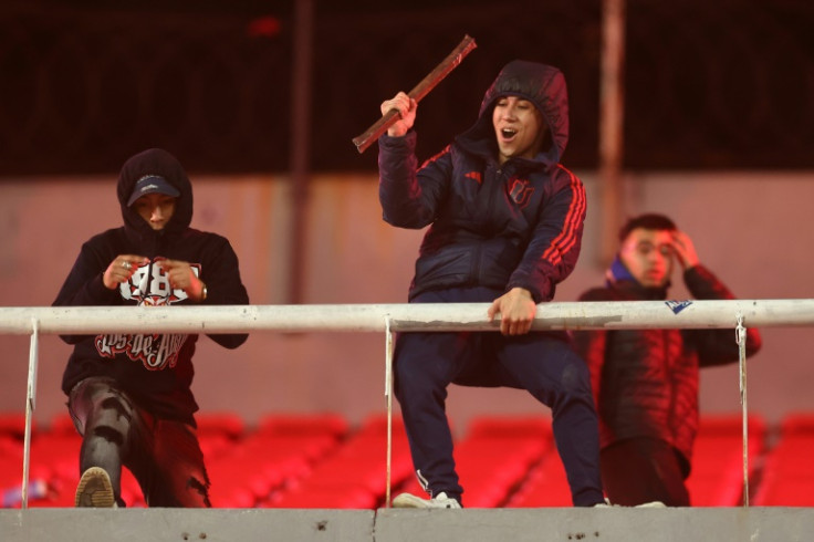 Supporters threw objects and the match was eventually abandoned