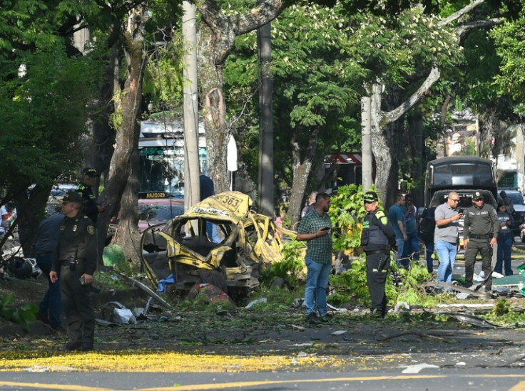 Colombian police inspect the area of a bomb explosion in Cali, Colombia, after five people were killed