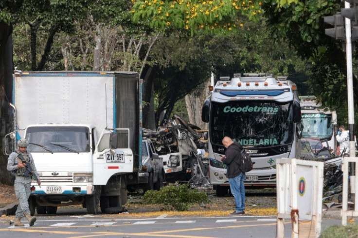 Members of Colombian security forces inspect the area of a bomb explosion in cali, Colombia on August 21 2025. Five people were killed and dozens were injured when a vehicle bomb targeted a military base on a busy street in the Colombian city of Cali on A