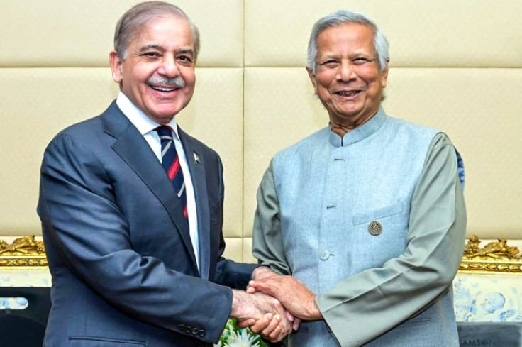 Pakistan's Prime Minister Shehbaz Sharif (L) shakes hands with Bangladesh's interim leader Muhammad Yunus on the sidelines of a summit in Cairo in 2024