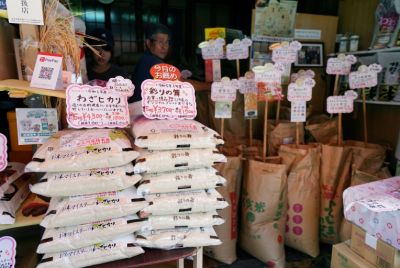 Bags of rice are seen at the entrance of a shop in Tokyo. Rice prices soared 90.7 percent in July year-on-year, but the rate of increase slowed from previous months