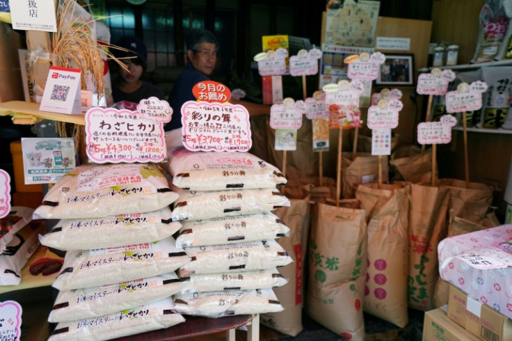 Bags of rice are seen at the entrance of a shop in Tokyo. Rice prices soared 90.7 percent in July year-on-year, but the rate of increase slowed from previous months