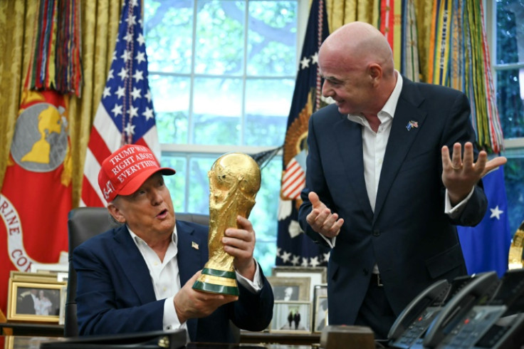 US President Donald Trump, with FIFA president Gianni Infantino, holds the World Cup Trophy in the Oval Office