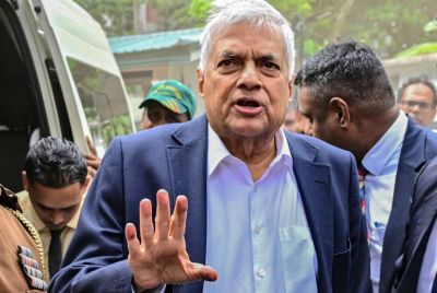 Sri Lanka's former president Ranil Wickremesinghe gestures as he arrives to appear before a court after his arrest