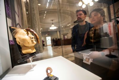 Visitors to the Mutter Museum in Philadelphia, Pennsylvania examine one of its most famous displays: the wax model of Madame Dimanche, a woman from Paris with a cutaneous growth resembling a horn