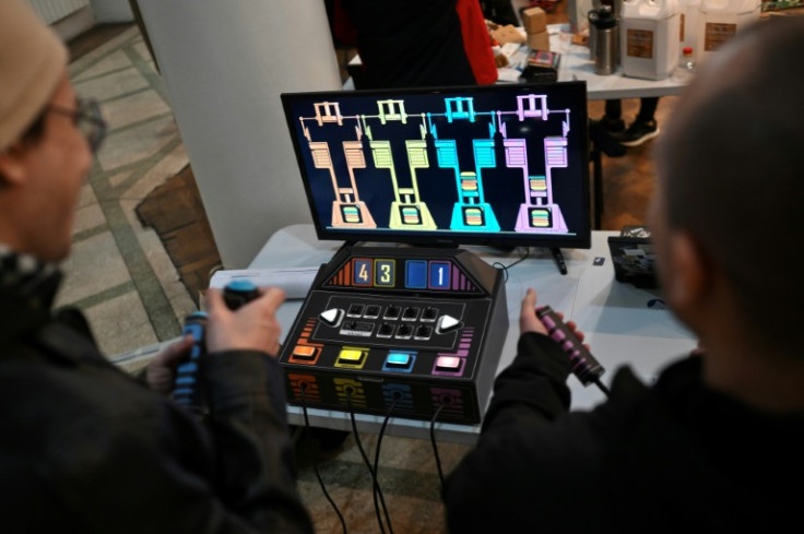 Men play a video game made from used and recycled electronic components during the 3rd Federal Cyberciruja Meeting in Buenos Aires