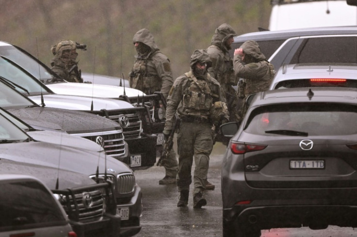 Australian police say their priority is to catch a gunman accused of killing two officers