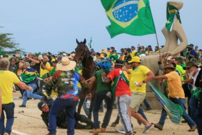A police officer falls from his horse during clashes with Bolsonaro supporters after an invasion of Planalto Presidential Palace in 2023