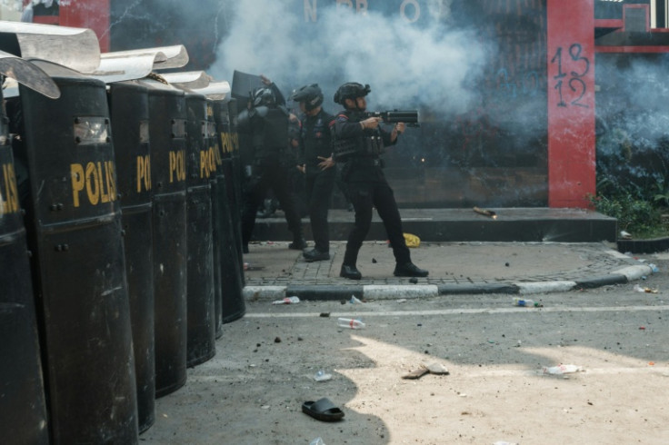 Members of the Mobile Brigade Corps, or 'Brimob' during clashes with people protesting against the death of a motorcycle taxi driver