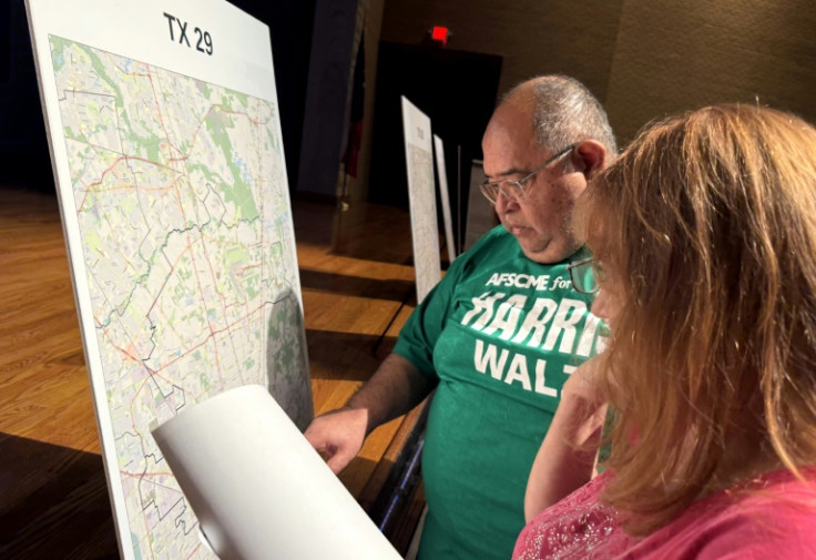 Voters look at a map to understand the new redistricting maps approved by Texas lawmakers for the 2026 midterm elections